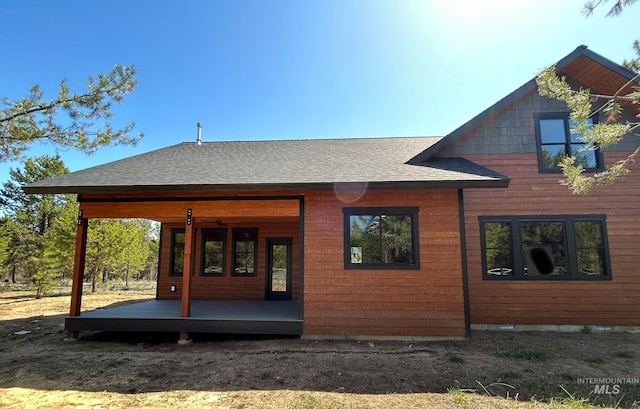 rear view of property featuring a deck