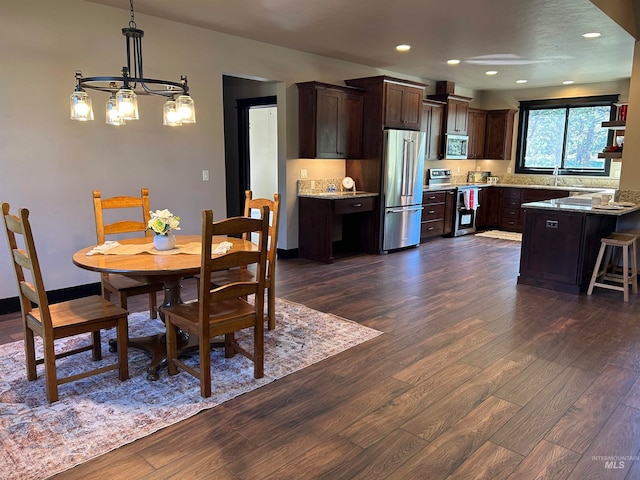 dining area featuring dark hardwood / wood-style flooring and a chandelier