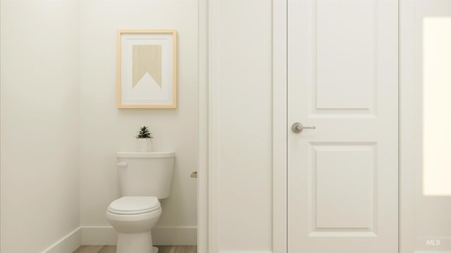 bathroom featuring hardwood / wood-style floors and toilet