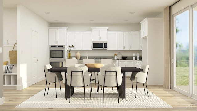kitchen with white cabinetry, appliances with stainless steel finishes, and light hardwood / wood-style flooring