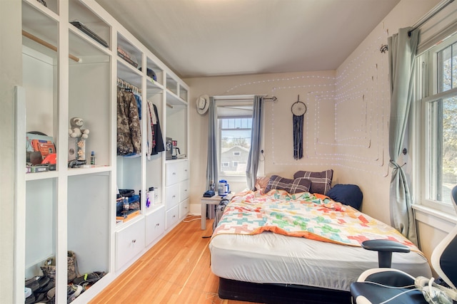 bedroom with wood-type flooring and multiple windows