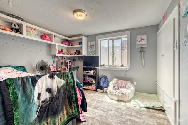 bedroom featuring a textured ceiling and hardwood / wood-style flooring