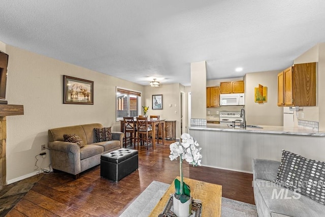 601 Hemlock St Unit 3, Mccall, ID 83638 - living area featuring dark wood-type flooring and baseboards