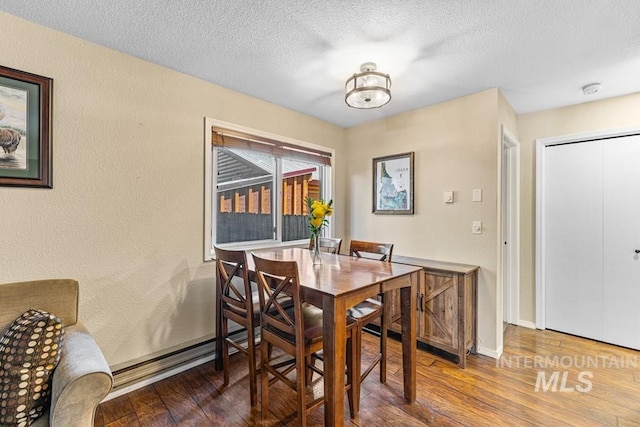 601 Hemlock St Unit 3, Mccall, ID 83638 - dining area with hardwood / wood-style flooring and a textured ceiling