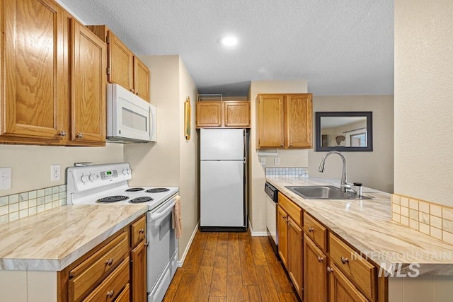 601 Hemlock St Unit 3, Mccall, ID 83638 - kitchen with white appliances, light countertops, dark wood-style flooring, a textured ceiling, and brown cabinetry