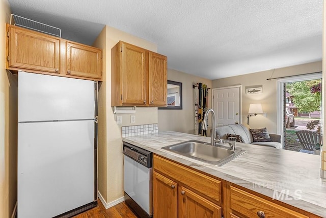 601 Hemlock St Unit 3, Mccall, ID 83638 - kitchen featuring freestanding refrigerator, dishwashing machine, light countertops, dark wood-style floors, and a textured ceiling