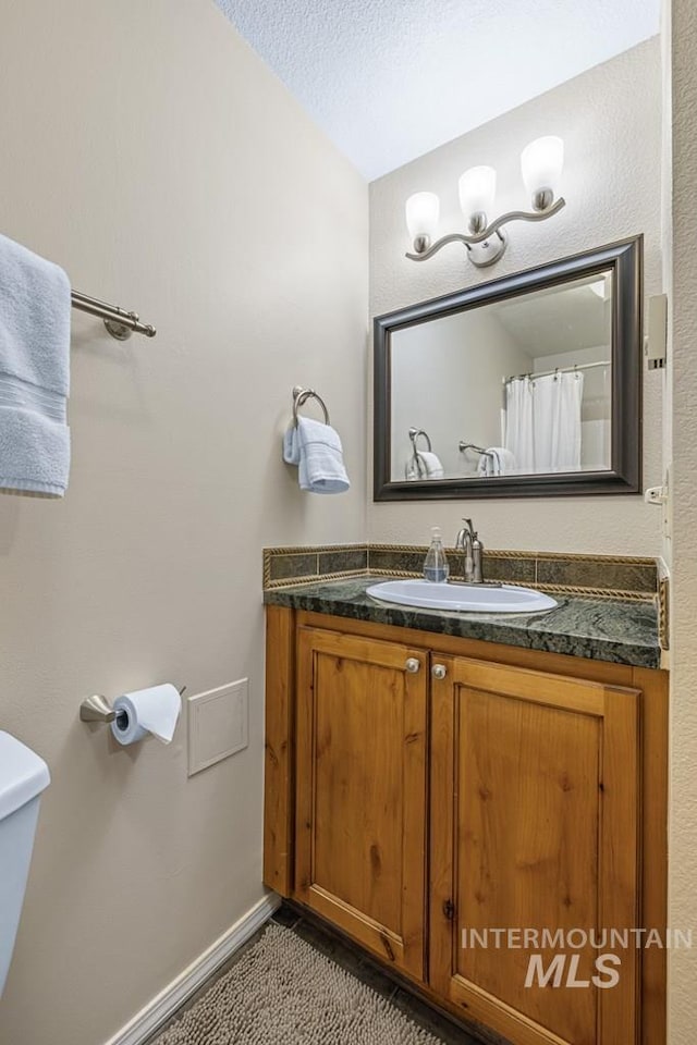 601 Hemlock St Unit 3, Mccall, ID 83638 - full bathroom with vanity, tile patterned flooring, a textured ceiling, and a shower with curtain
