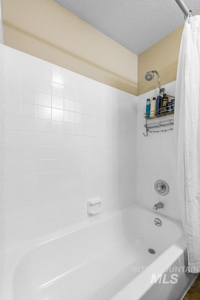 601 Hemlock St Unit 3, Mccall, ID 83638 - full bathroom featuring shower / bath combo and a textured ceiling