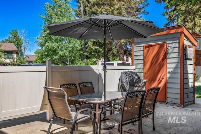 601 Hemlock St Unit 3, Mccall, ID 83638 - view of patio with outdoor dining space and a shed