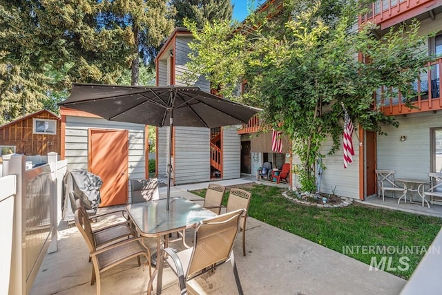 601 Hemlock St Unit 3, Mccall, ID 83638 - view of patio featuring outdoor dining area and a storage unit