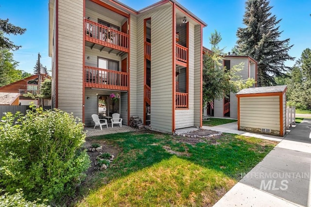 601 Hemlock St Unit 3, Mccall, ID 83638 - back of house with a balcony, a yard, and a storage unit