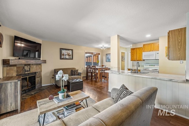 601 Hemlock St Unit 3, Mccall, ID 83638 - living room with a fireplace and dark wood finished floors