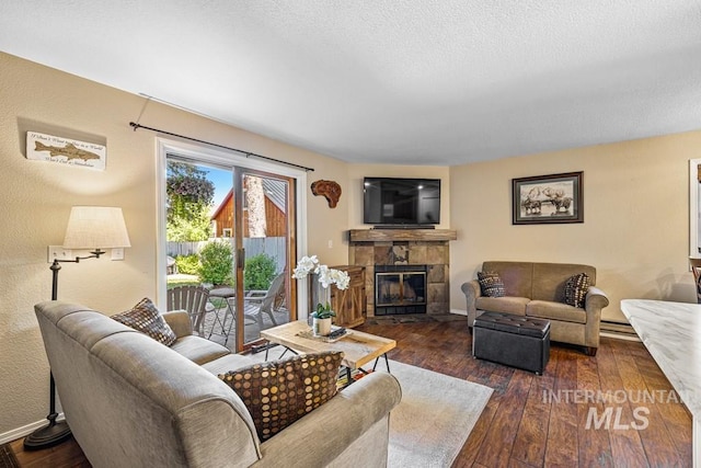 601 Hemlock St Unit 3, Mccall, ID 83638 - living area with hardwood / wood-style flooring, a fireplace with flush hearth, and a textured ceiling