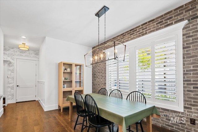 3345 W Dublin St, Eagle, ID 83616 - dining area featuring a chandelier, dark wood-style floors, brick wall, and baseboards