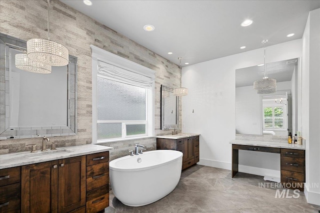 3345 W Dublin St, Eagle, ID 83616 - bathroom with a chandelier, two vanities, a freestanding tub, recessed lighting, and baseboards