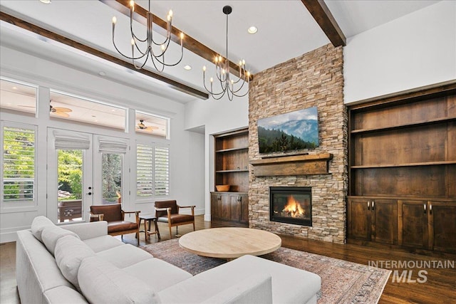 3345 W Dublin St, Eagle, ID 83616 - living area with beam ceiling, wood finished floors, a stone fireplace, baseboards, and a chandelier
