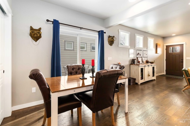 dining space with beam ceiling, dark wood-style flooring, and baseboards