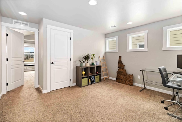 office area featuring light carpet, a wealth of natural light, visible vents, and recessed lighting