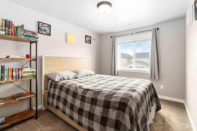 carpeted bedroom featuring visible vents and baseboards