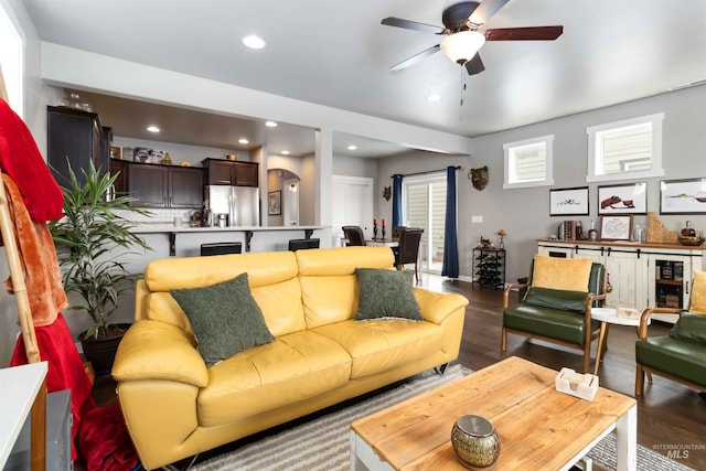 living area with wood finished floors, a ceiling fan, and recessed lighting