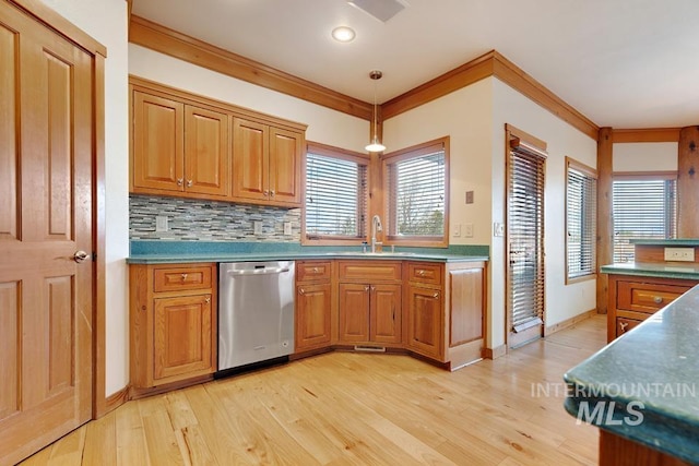 kitchen with pendant lighting, dishwasher, backsplash, sink, and light hardwood / wood-style floors