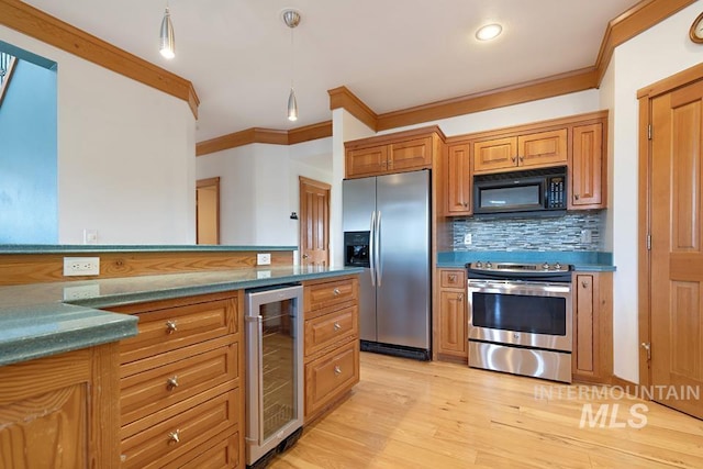 kitchen featuring crown molding, tasteful backsplash, decorative light fixtures, stainless steel appliances, and beverage cooler