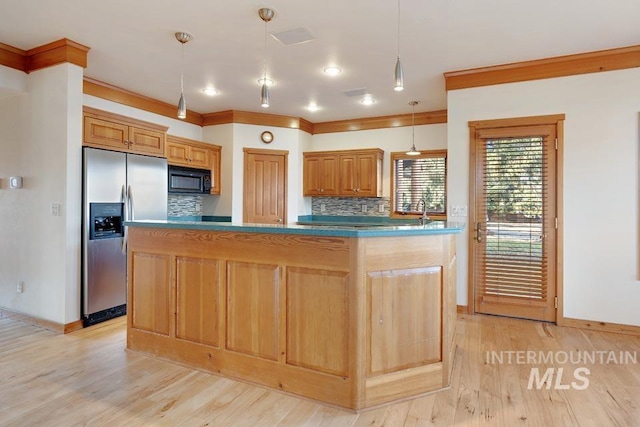 kitchen with backsplash, a center island, pendant lighting, and stainless steel refrigerator with ice dispenser