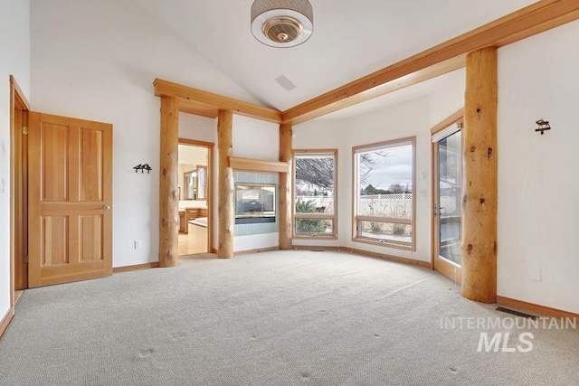 interior space with high vaulted ceiling and light colored carpet