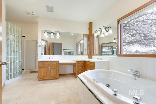 bathroom featuring tile patterned floors, plus walk in shower, and vanity