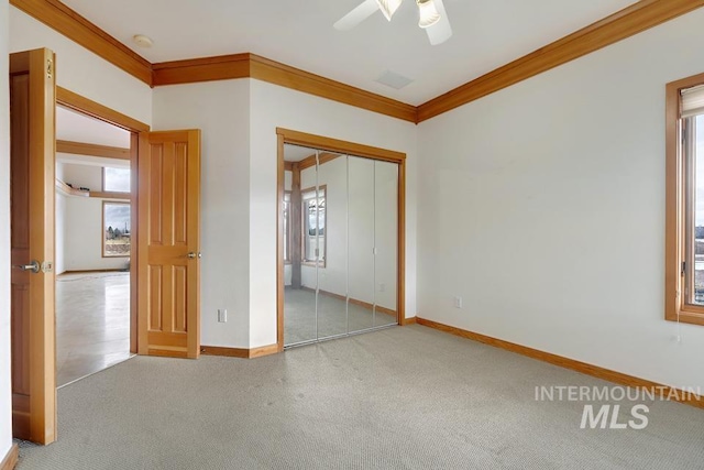 empty room with ceiling fan and crown molding