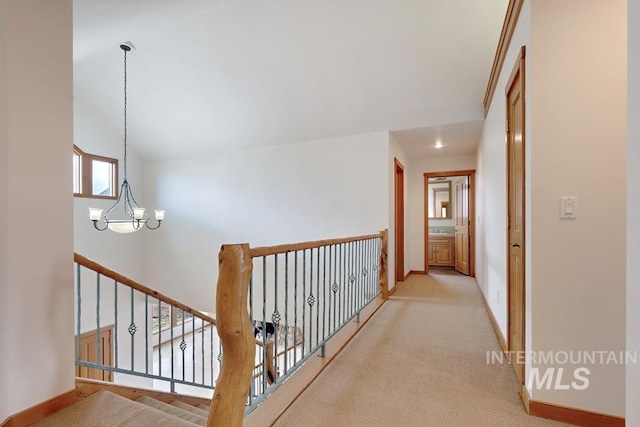 hall featuring a chandelier and light colored carpet