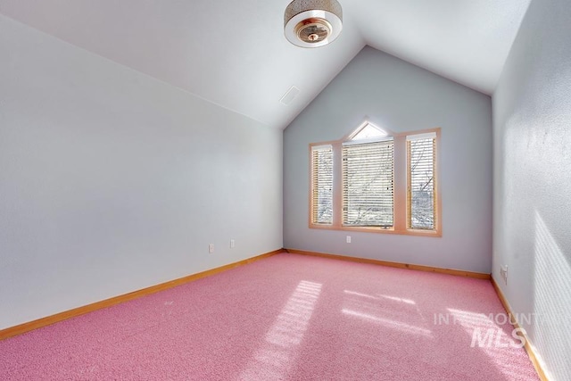 unfurnished room with light colored carpet and vaulted ceiling