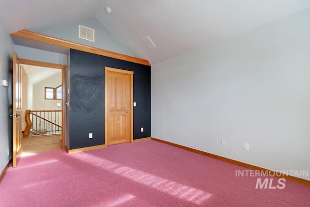 unfurnished bedroom featuring carpet and lofted ceiling