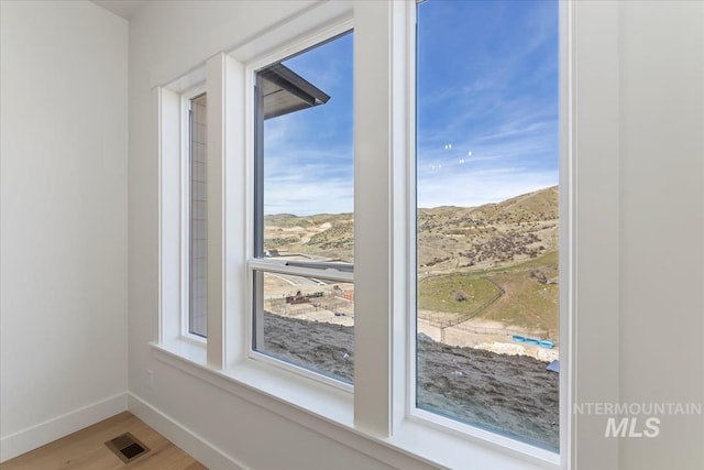 6535 S Evie Way, Eagle, ID 83714 - detailed view of wood finished floors, baseboards, and a mountain backdrop