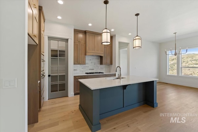6535 S Evie Way, Eagle, ID 83714 - kitchen featuring a sink, backsplash, gas stovetop, light wood-style flooring, and recessed lighting