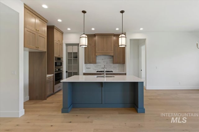 6535 S Evie Way, Eagle, ID 83714 - kitchen with baseboards, decorative backsplash, light countertops, light wood-type flooring, and recessed lighting