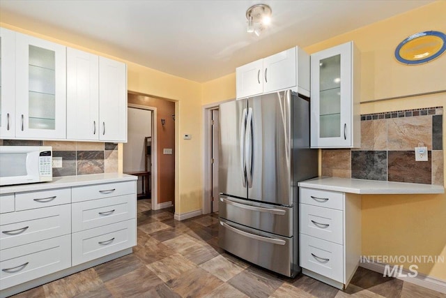 120 W Main St, Hagerman, ID 83332 - kitchen with stainless steel refrigerator, decorative backsplash, and white cabinets