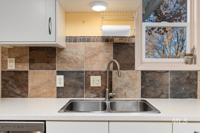 120 W Main St, Hagerman, ID 83332 - kitchen with white cabinets, stainless steel dishwasher, sink, and tasteful backsplash