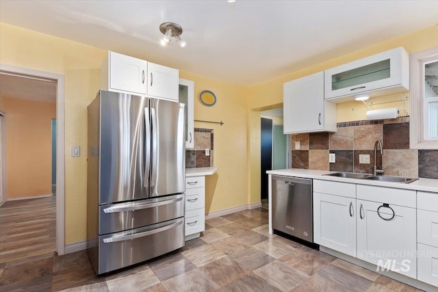 120 W Main St, Hagerman, ID 83332 - kitchen with white cabinets, backsplash, stainless steel appliances, and sink