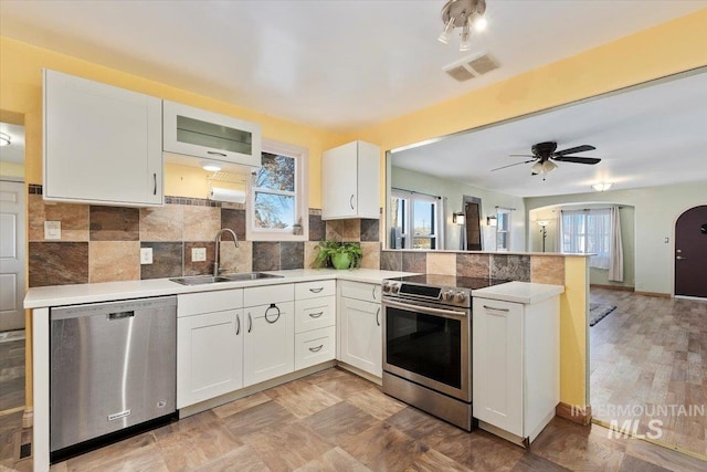 120 W Main St, Hagerman, ID 83332 - kitchen with white cabinets, stainless steel appliances, ceiling fan, and sink