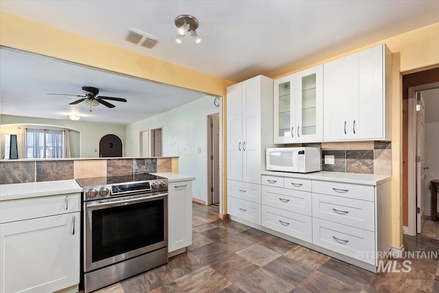 120 W Main St, Hagerman, ID 83332 - kitchen with white cabinets, ceiling fan, electric stove, and tasteful backsplash