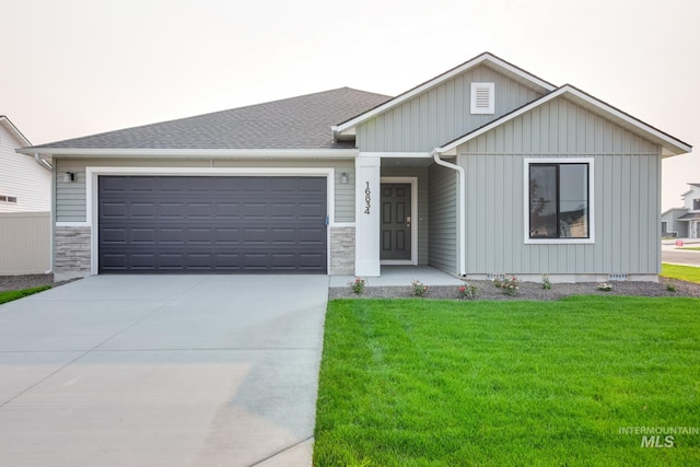 view of front of home with a front yard and a garage