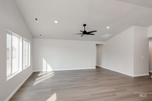 spare room with light hardwood / wood-style flooring, ceiling fan, and lofted ceiling