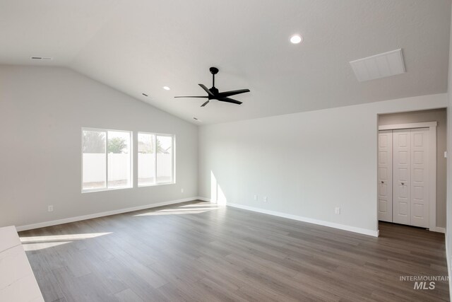 unfurnished room with ceiling fan, wood-type flooring, and lofted ceiling