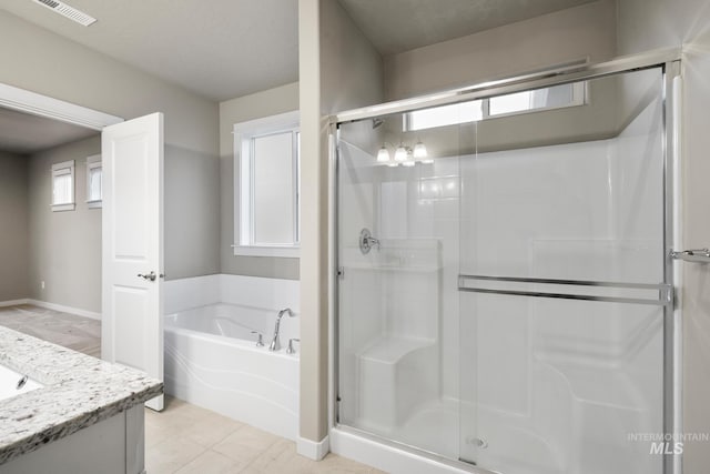 10449 W Thimbleberry Dr, Star, ID 83669 - bathroom with a stall shower, a bath, and vanity