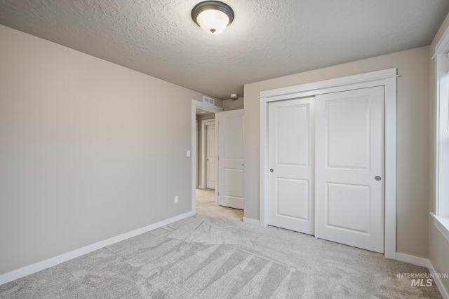 10449 W Thimbleberry Dr, Star, ID 83669 - unfurnished bedroom with light colored carpet, a closet, and a textured ceiling