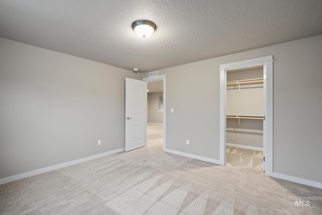 10449 W Thimbleberry Dr, Star, ID 83669 - unfurnished bedroom featuring a textured ceiling, light carpet, a spacious closet, and a closet