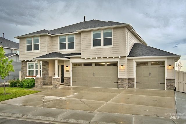 10449 W Thimbleberry Dr, Star, ID 83669 - view of front of property featuring stone siding, driveway, a garage, and an attached garage