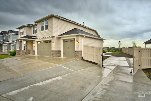 10449 W Thimbleberry Dr, Star, ID 83669 - view of front facade with stone siding, concrete driveway, an attached garage, and roof with shingles