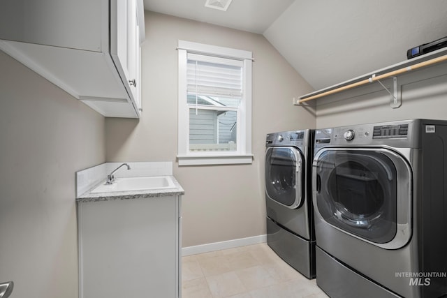 10449 W Thimbleberry Dr, Star, ID 83669 - laundry area featuring washer and clothes dryer, cabinet space, and light tile patterned flooring